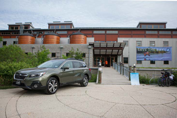 A green Subaru Outback parked in front of the Chesapeake Bay Foundation headquarters in Annapolis, Maryland