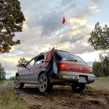 A Subaru Impreza Outback Sport on a muddy dirt trail during the Gambler 500.