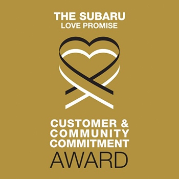 The logo for the Subaru Love Promise Customer & Community Commitment Award. It has a double heart in the center and a gold background.