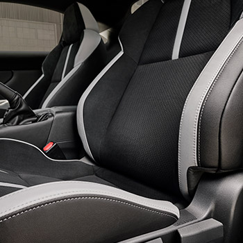 Close-up of a front seat with gray leather bolster inside the 2025 Subaru BRZ Series.Purple