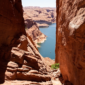 A view of Lake Powell through a rock formation.