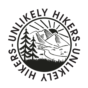 The Unlikely Hikers logo, which is circular in shape with an illustration in the center that fills the circle. The illustration is of a landscape scene, with mountains and the sun shining behind them, a creek running from the mountains and evergreen trees in the foreground.