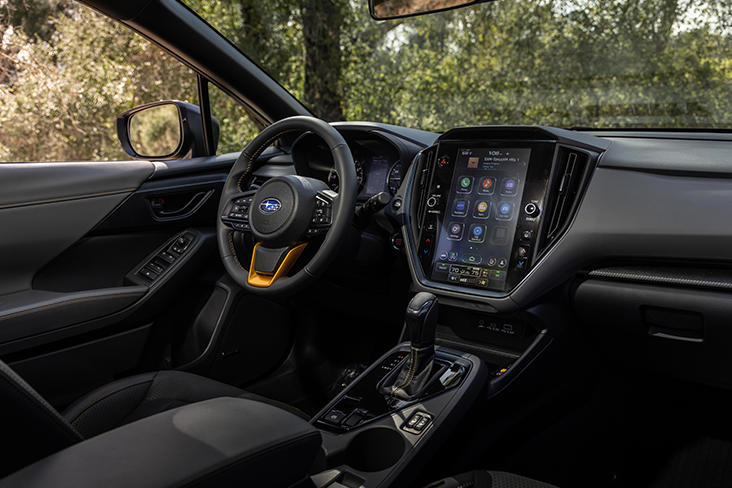 A view of the driver's seat, steering wheel, and 11.6-inch Multimedia Plus system of the Subaru Crosstrek Wilderness.
