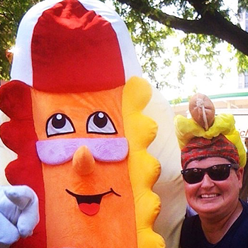 Dibs Baer next to a hotdog costume