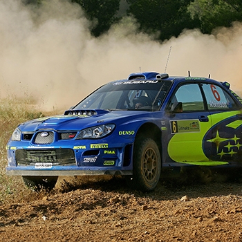 Chris Atkinson driving a Subaru rally car at the Acropolis Rally.