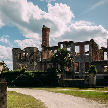 Ruins of an old building on Cumberland Island against a bright sunny sky.
