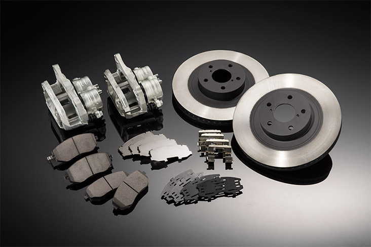 Image of brakes disassembled, including rotors, brake pads, calipers and clips.