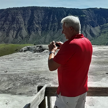 J.R. Wilhite’s brother, Bob, enjoying a scenic view of a mountainous landscape during their travels.