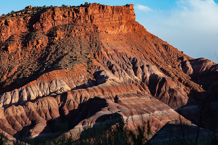 Layers of colored rock seen along the Paria River Valley at sunset.