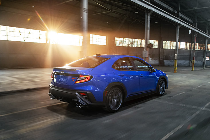 A rear 3/4 view of the 2025 Subaru WRX tS in motion