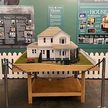 A replica of the farmhouse from the movie Field of Dreams in a display at the If You Build It Exhibit.