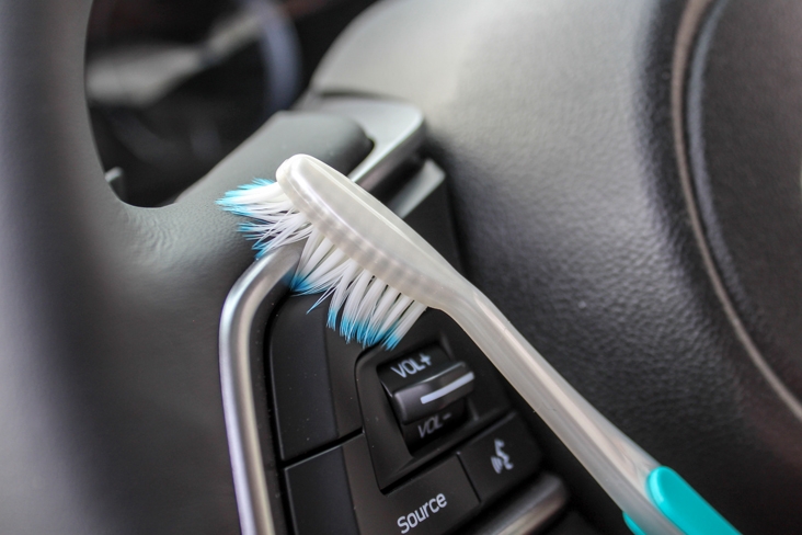 Cleaning steering wheel of 2019 3-row Subaru Ascent with toothbrush