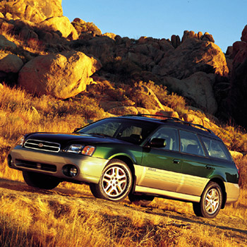 Image of the Legacy Outback, a trim of the Legacy Wagon. The vehicle has two-tone paint, raised ground clearance and a raised roof.