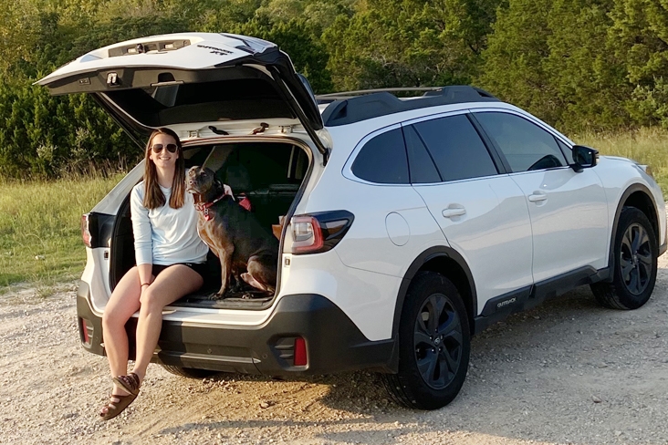 Janessa Rocco with her dog sitting in her Subaru.