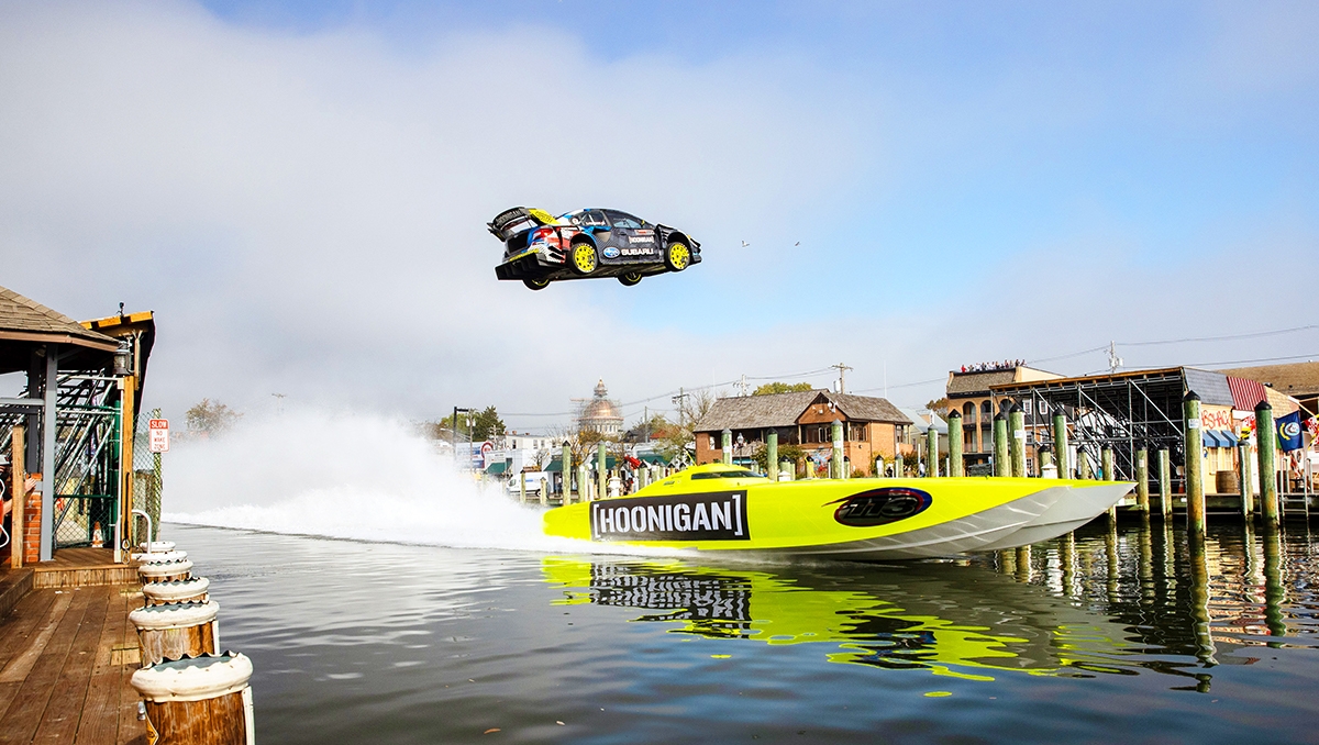 Subaru Rally Team Driver Travis Pastrana jumps over a speedboat in a specially prepared Subaru WRX STI