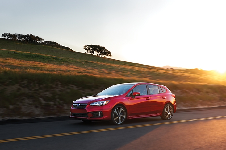 2021 Subaru Impreza Sport 5-Door in Lithium Red Pearl driving in the country