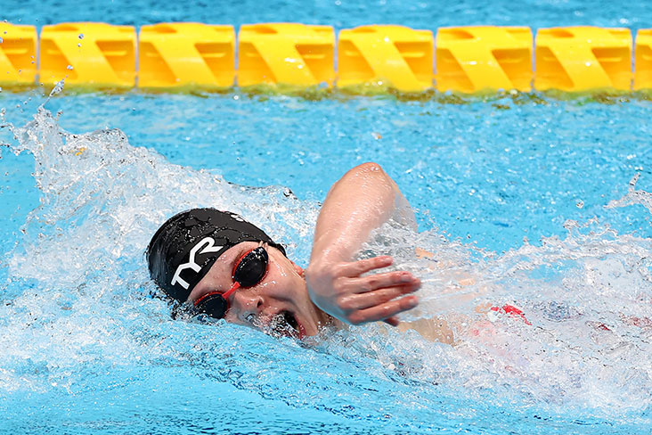 Morgan Stickney competing at the 2020 Paralympic Games on September 2, 2021. She is in the water swimming, wearing a swimming cap and goggles, with her head turned to take a quick breath.