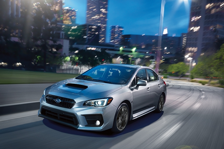 2021 Subaru WRX Limited in Ice Silver Metallic driving through a city at night