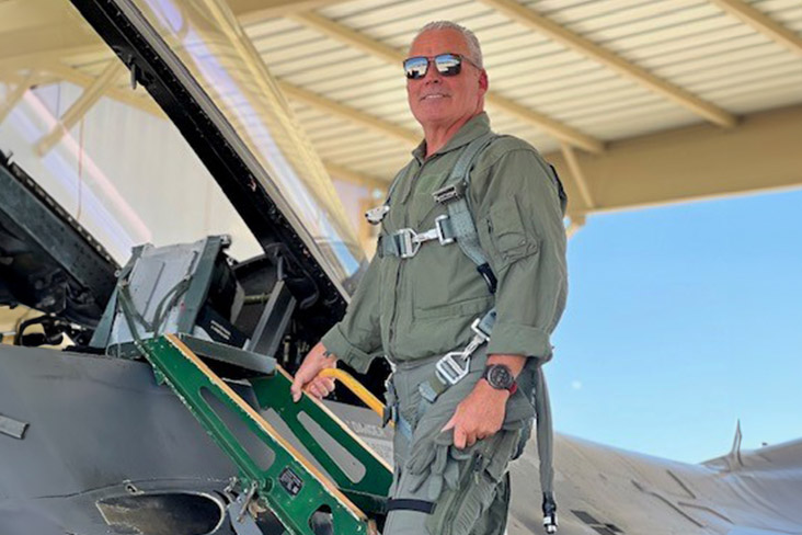  Mark Mauer is climbing the ladder of an F-16. He is suited up for a ride in the jet fighter aircraft.