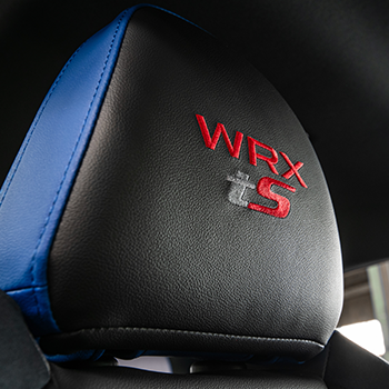 Close-up of WRX tS embroidered on a front headrest