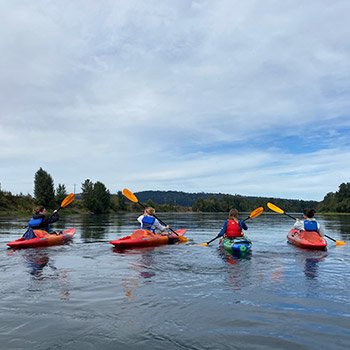 A group of four kayakers on Willamette River
