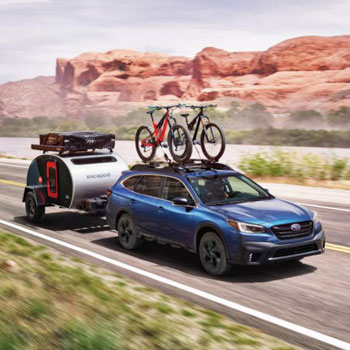  2020 Subaru Outback with trailer and two bikes on bike carrier