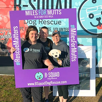 B-Squad director Mandi Haase, left, with her daughter Reagan and volunteer Ashley Carrison at the Miles for Mutts 5k & Family Dog Walk. 