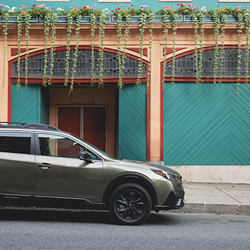 2020 Outback in front of building with hanging plants