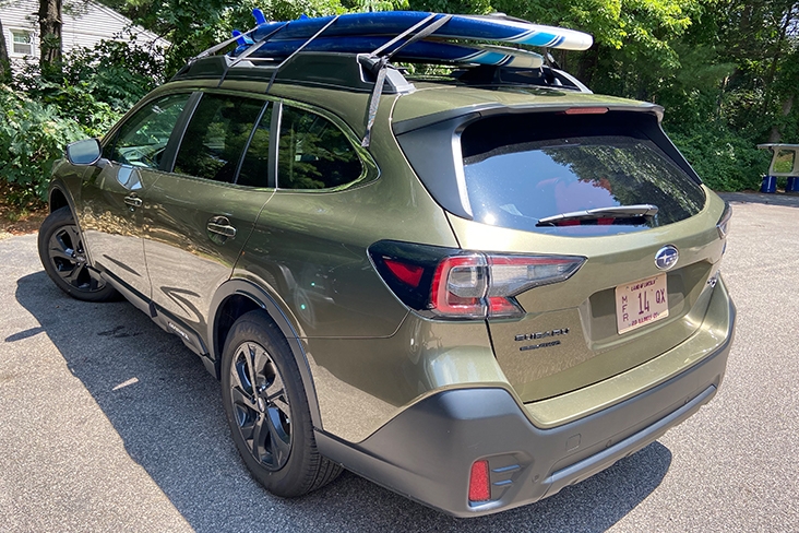 Backside shot of a 2020 Subaru Outback Onyx Edition XT with surfboards on top