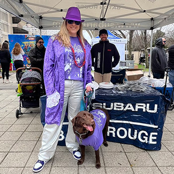 Janelle Stockwell stands with her rescue dog, Princess, at the Mystic Krewe of Mutts event.