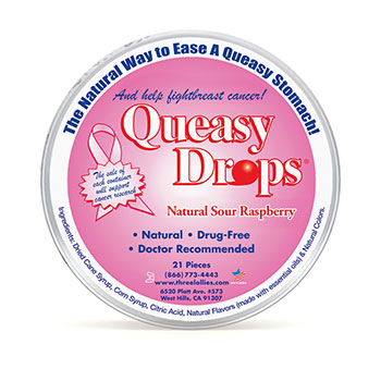 A round tin with a pink label. Around the edge of the tin it says, The Natural Way to Ease a Queasy Stomach! The brand name, Queasy Drops, is prominently displayed in the center. Underneath the brand name is the flavor, natural sour raspberry.