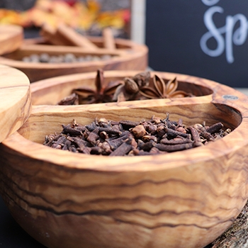 A wooden bowl holding spices.