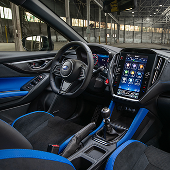 Interior view of driver's seat, steering wheel and 11.6-inch Multimedia Plus screen in 2025 Subaru WRX tS