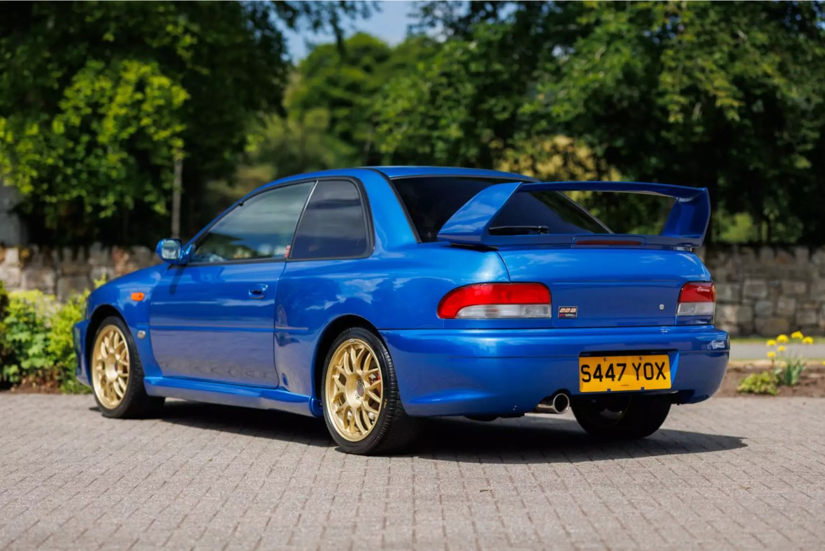 A full-body exterior shot from the rear of the Ex-Colin McRae 1998 Subaru Impreza 22B STi