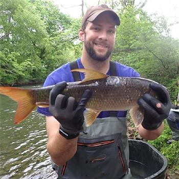 Luke Etchison holding a fish.