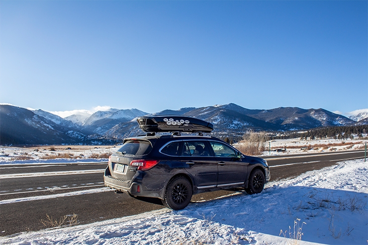 Snowy Subaru Outback driving on the highway