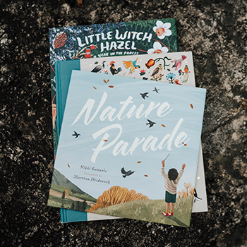 A small pile of children's books with Nature Parade on the top