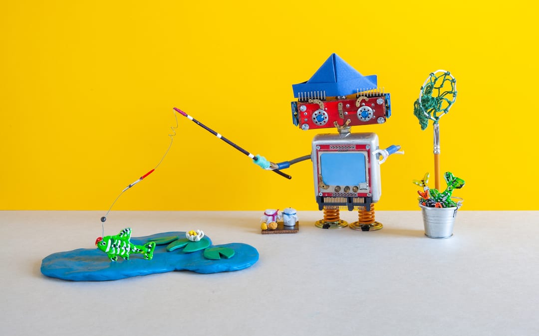 A,Toy,Robot,Catches,Fish.,Abstract,Miniature,Plasticine,Lake,And
