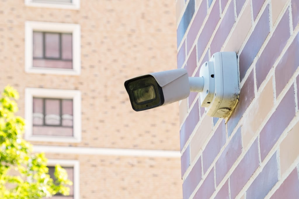 Small,White,Cctv,Cameras,On,A,Pole,Against,The,Background Small,White,Cctv,Cameras,On,A,Pole,Against,The,Background