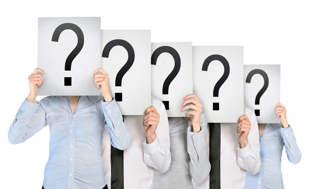 people holding up signs with a question mark on them people holding up signs with a question mark on them