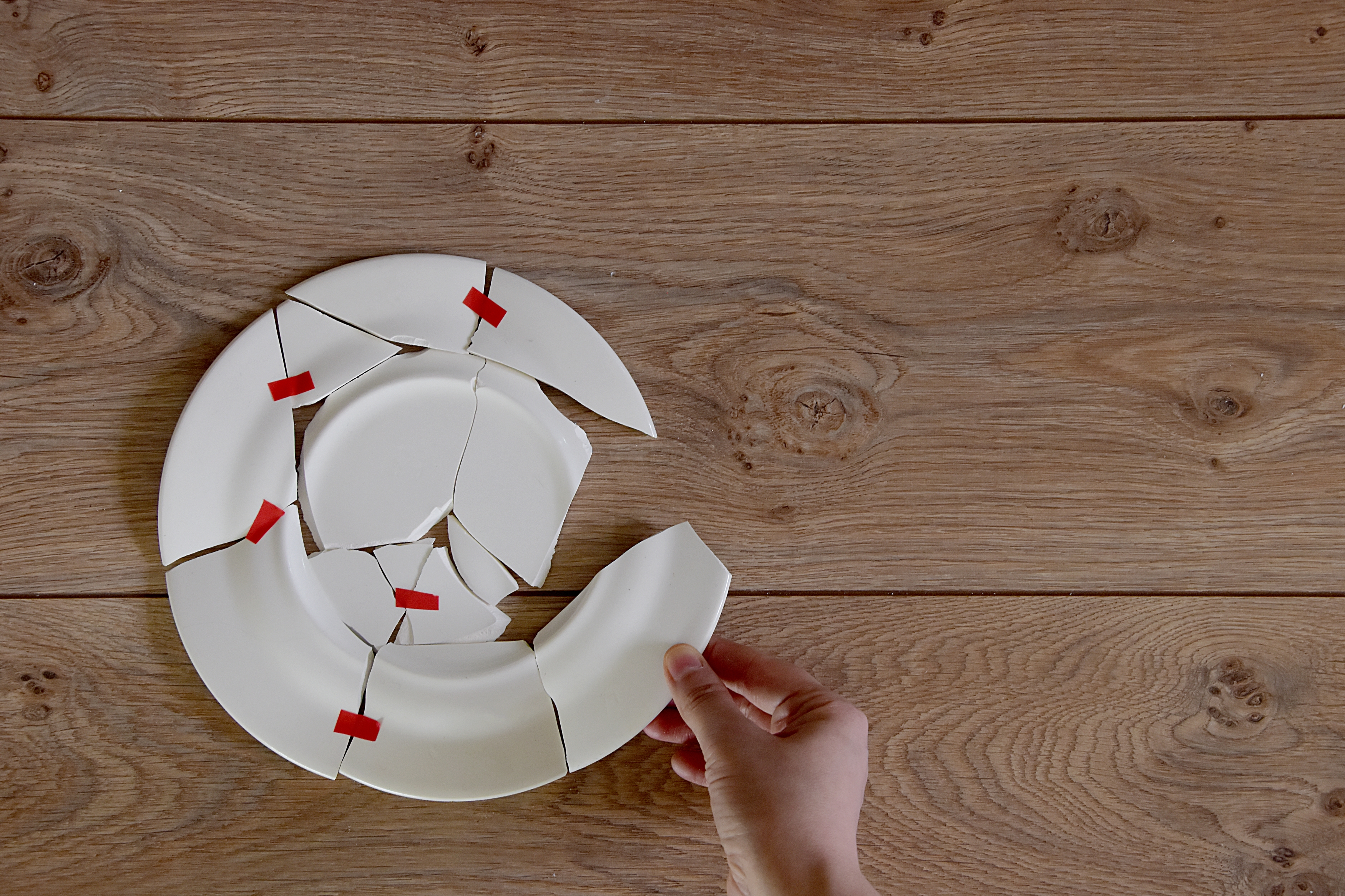 a shattered plate being reassembled