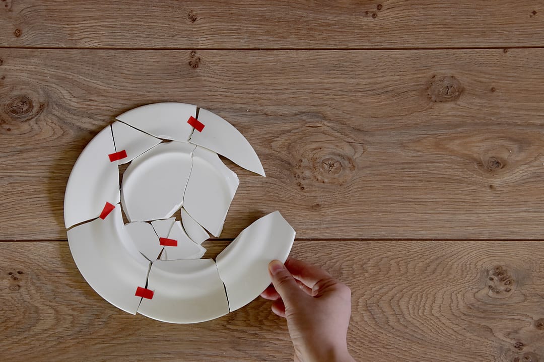 a shattered plate being reassembled