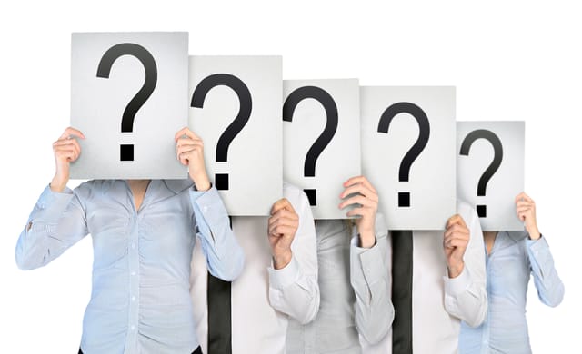 people holding up signs with a question mark on them people holding up signs with a question mark on them