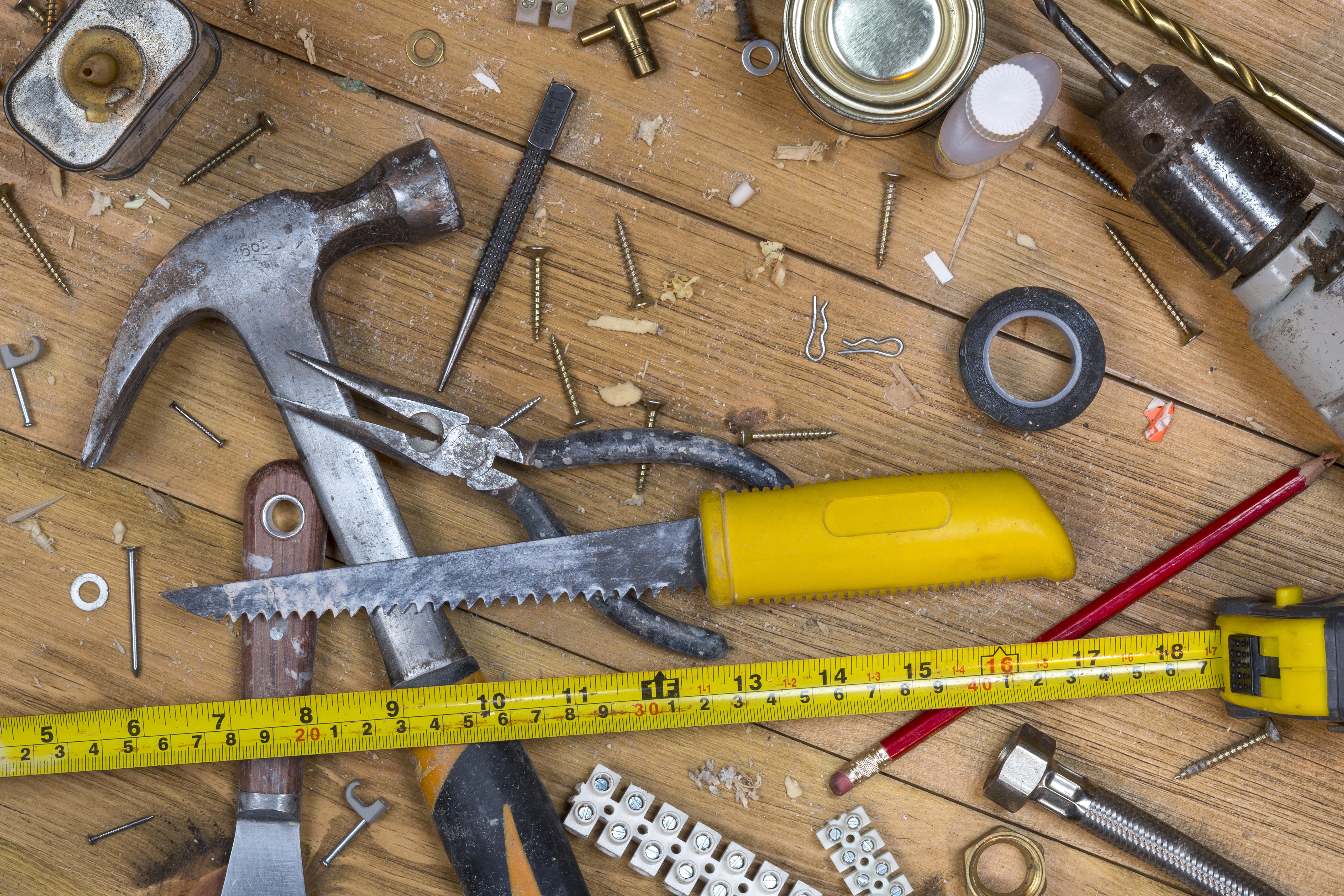 Home maintenance - An untidy workshop bench full of dusty old tools and screws.