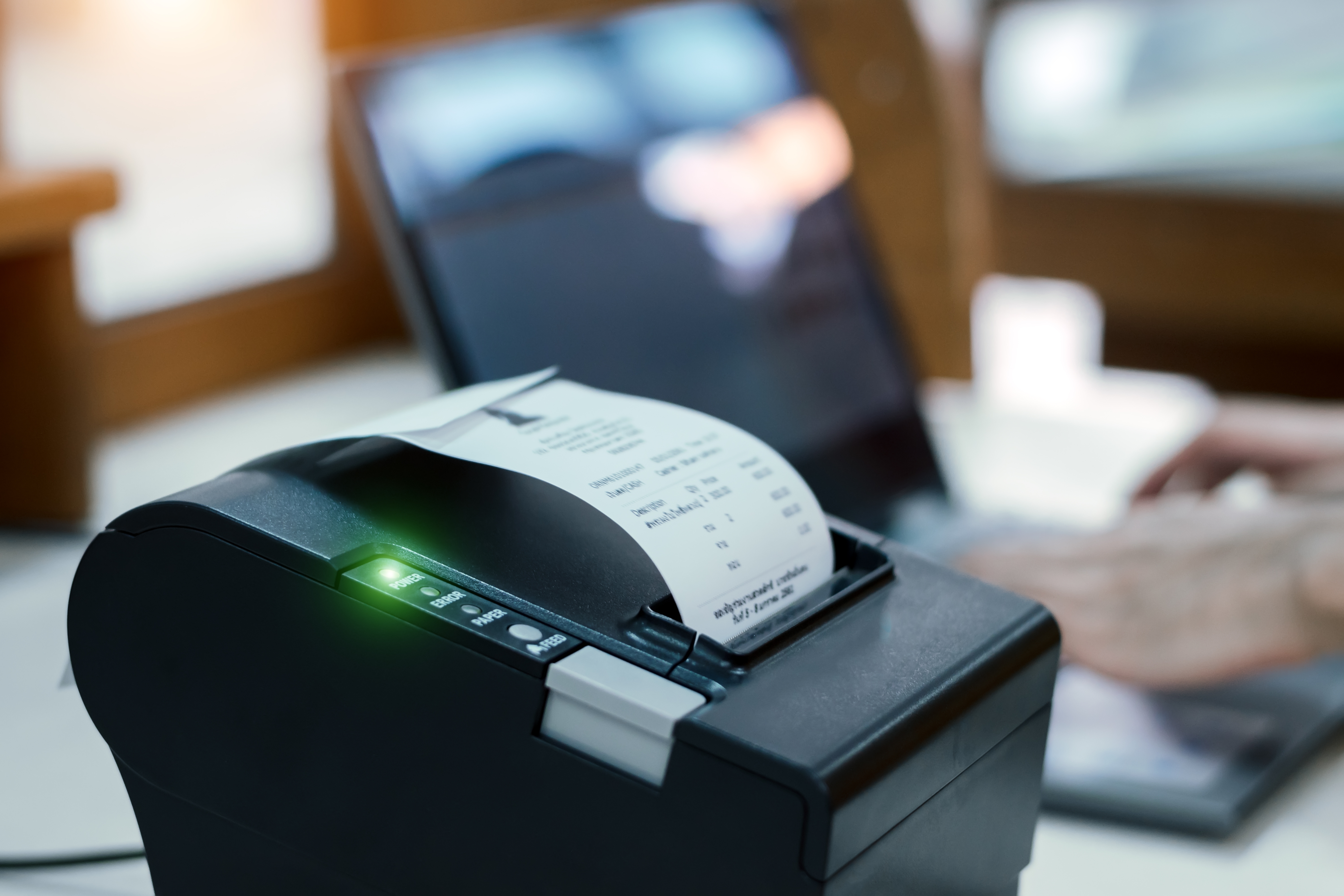 Cashier,Are,Recording,Sales,Data,On,Notebook,With,Thermal,Receipt