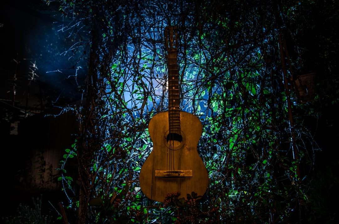 A,Wooden,Acoustic,Guitar,At,Night.,With,Spotlight,For,Your