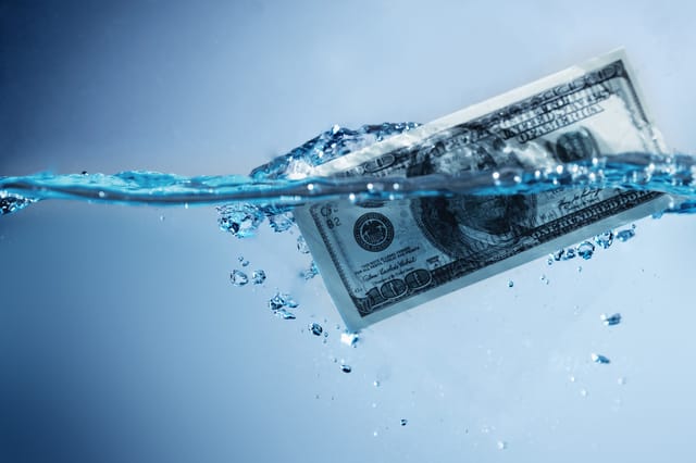 A photograph of a dollar-bill partly immersed in clear water, with bubbles A photograph of a dollar-bill partly immersed in clear water, with bubbles