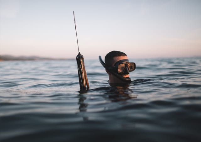 Spearfisherman Submerged Up To His Head Spearfisherman Submerged Up To His Head