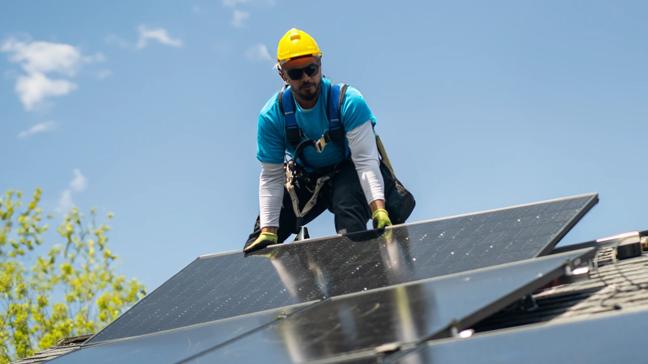 A solar installer on the roof.