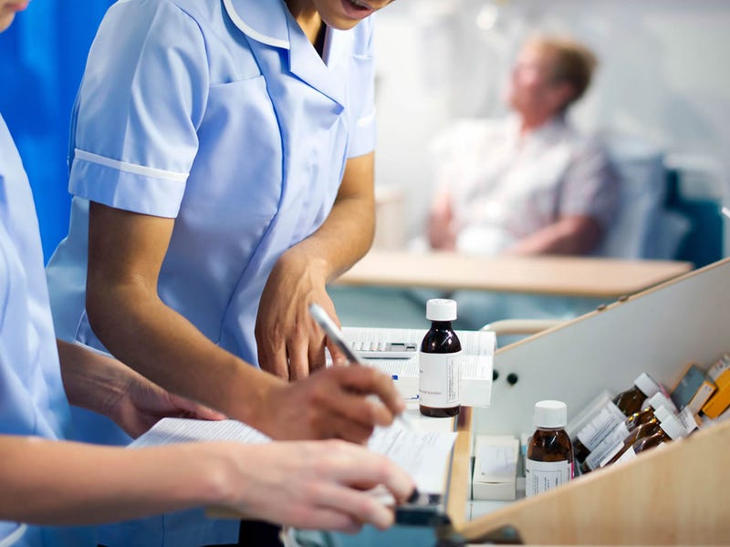 Dos mujeres enfermeras tomando notas en inglés